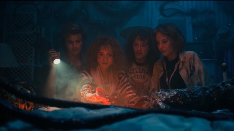 Teens in Stranger Things looking at a toy
