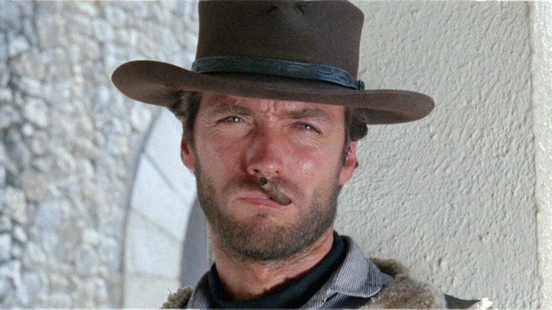 Clint Eastwood smokes a cigar in A Fistful of Dollars