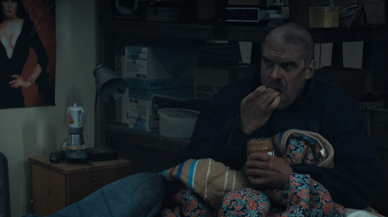 Hopper chowing down on peanut butter in Stranger Things